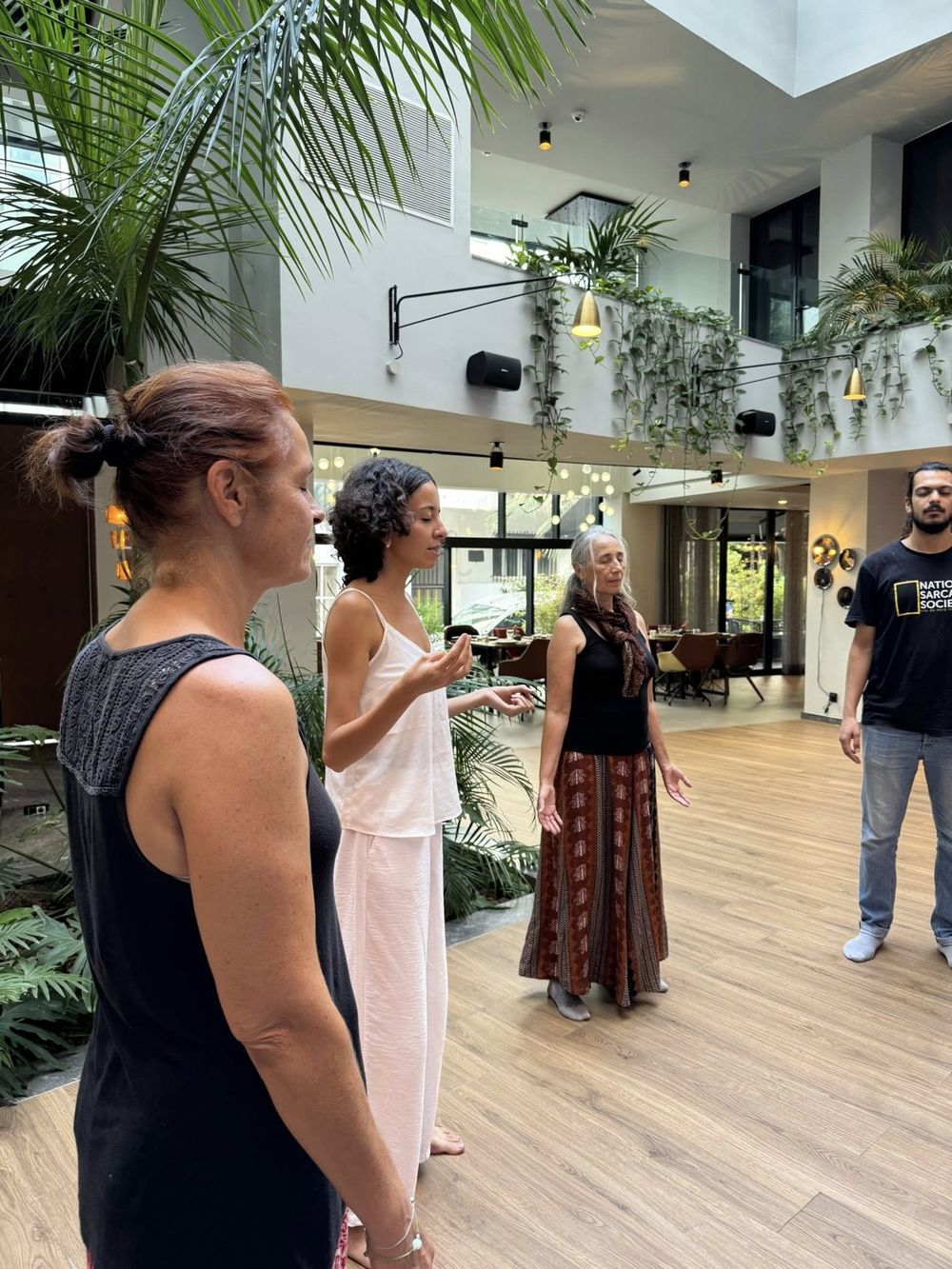 Standing meditation circle during an all-ages session