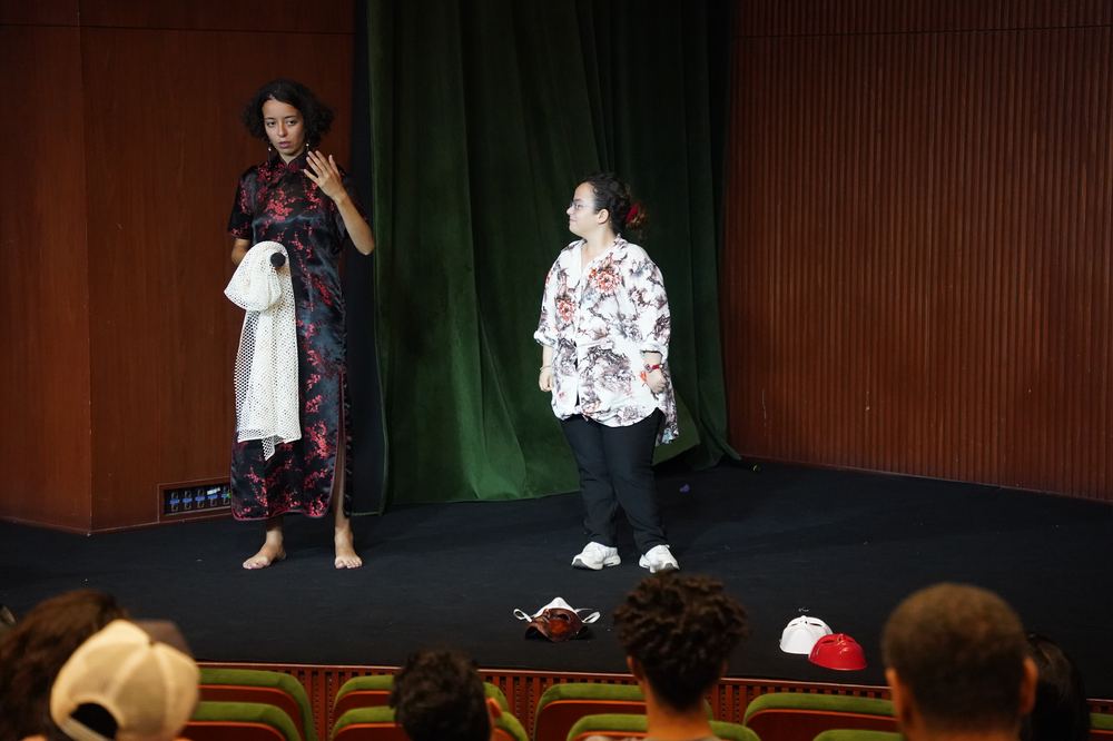 Two performers on stage during an inclusive theater piece