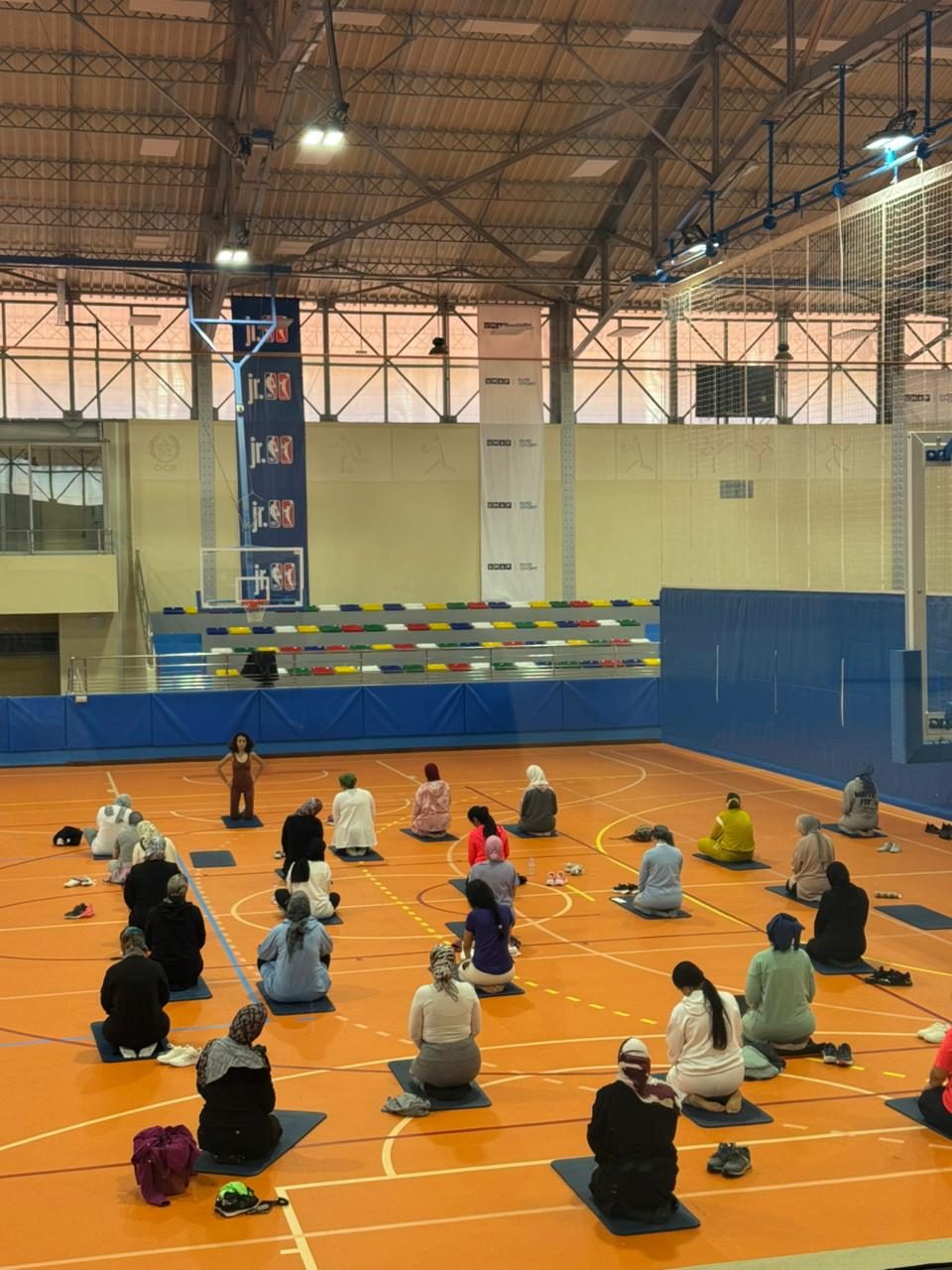 Group session on mats in a sports hall